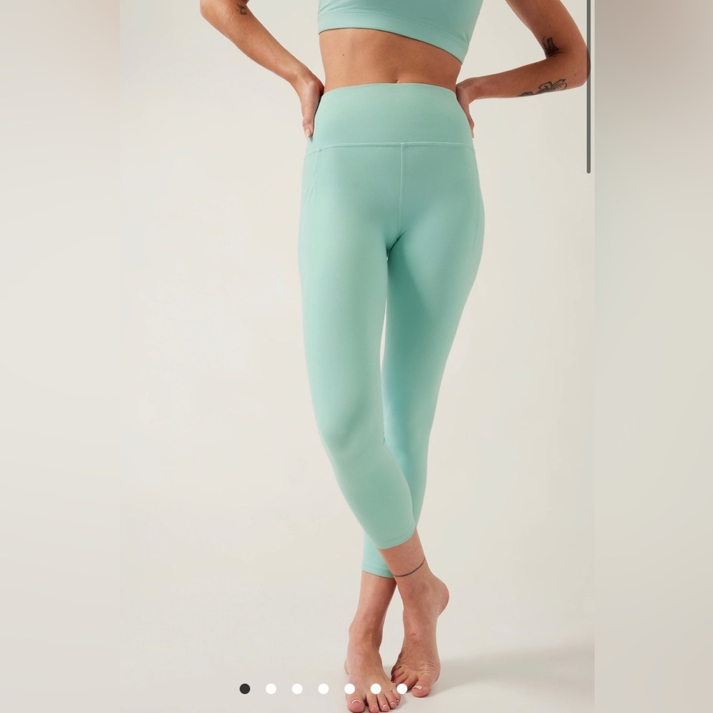 NEW with tags. Athleta Salutation Stash 7/8 Tight with pocket in reef green.